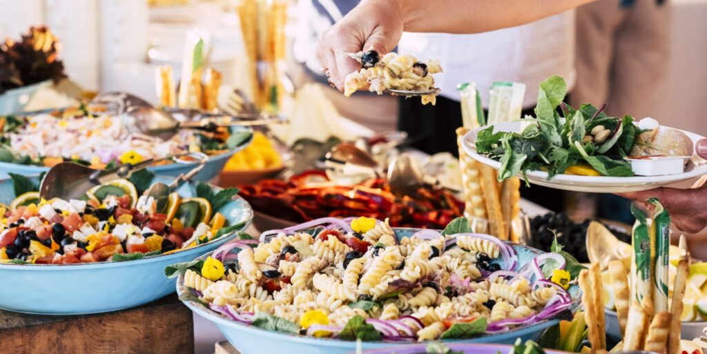 Heavenly hands funeral concierge close up view of people friends hands taking food from catering table during party